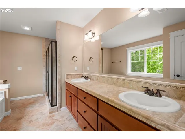 a bathroom with a sink double vanity granite and a mirror
