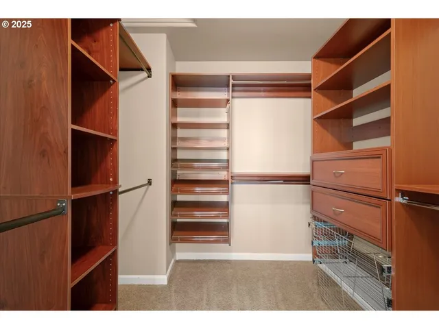 a view of walk in closet with empty racks