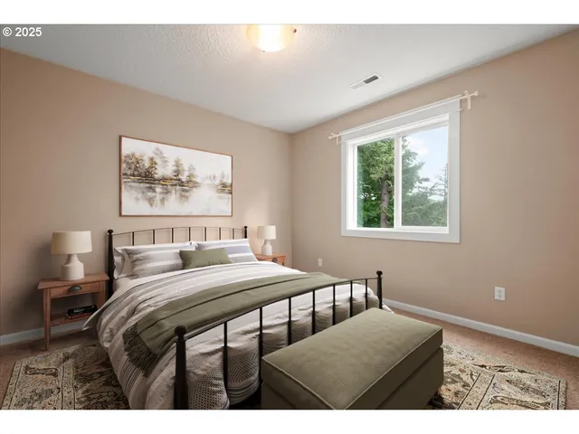 a bedroom with a bed a table and chair