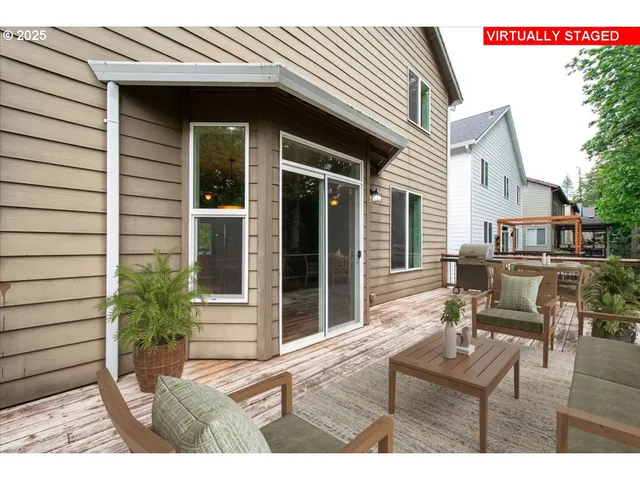 a view of a house with backyard and sitting area