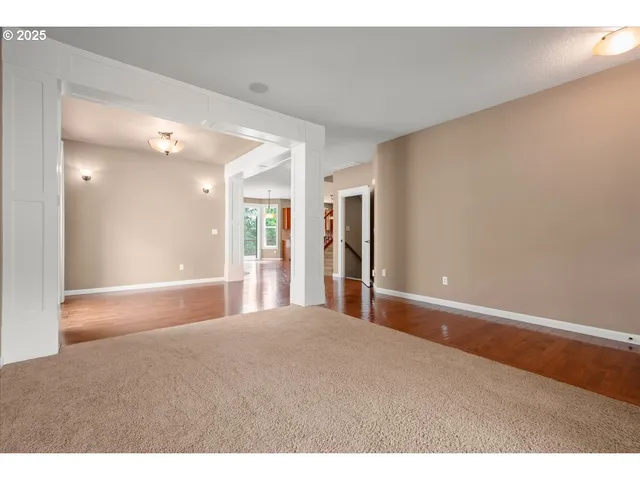 a view of an empty room with a kitchen