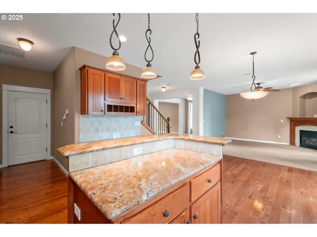 a view of a room with kitchen island and wooden floor