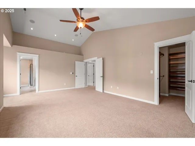 a view of a livingroom with a ceiling fan and window