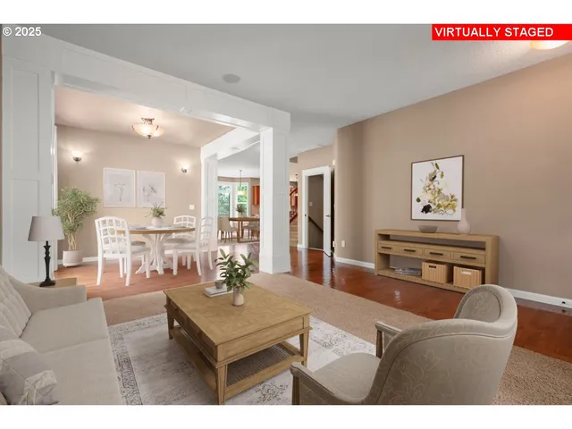 a living room with furniture and a dining table