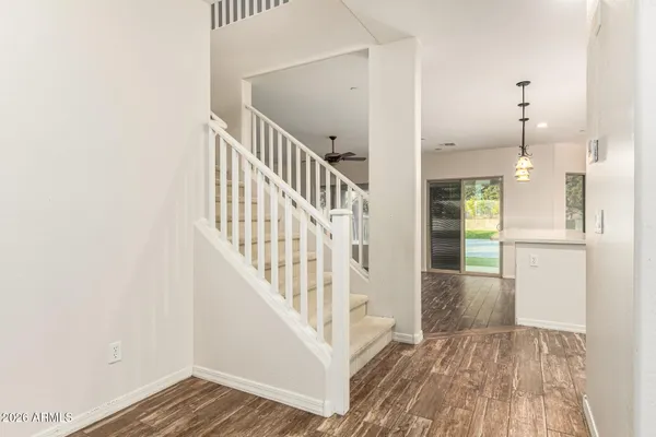 a view of a ceiling fan and hardwood floor