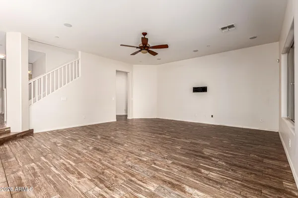 a view of a kitchen with a sink and wooden floor