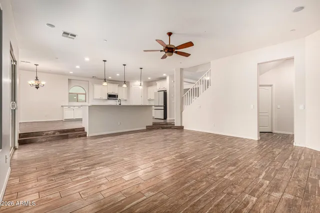 a view of a kitchen with wooden floor and a window