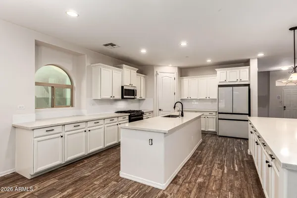 a kitchen with granite countertop a stove and a microwave