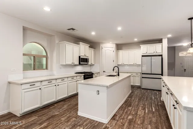 a kitchen with granite countertop a stove and a microwave