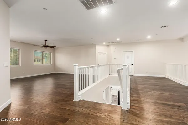 an empty room with wooden floor and closet