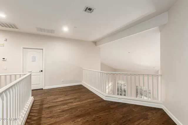 a bathroom with a double vanity sink and mirror with toilet