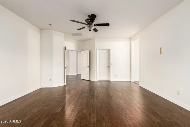 a view of a white house with a yard