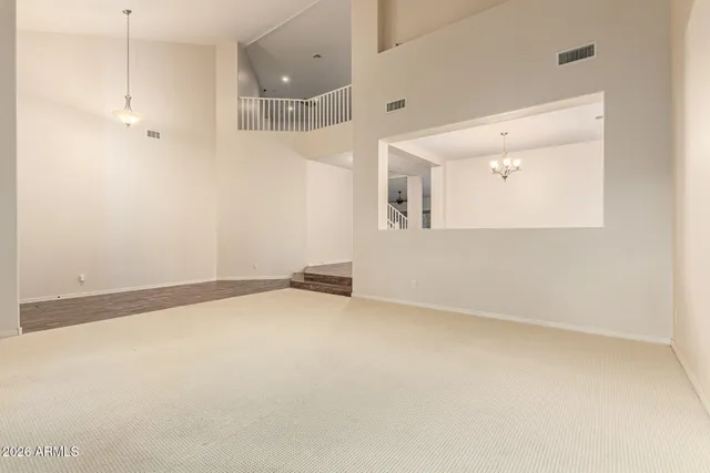 an empty room with entrance and windows