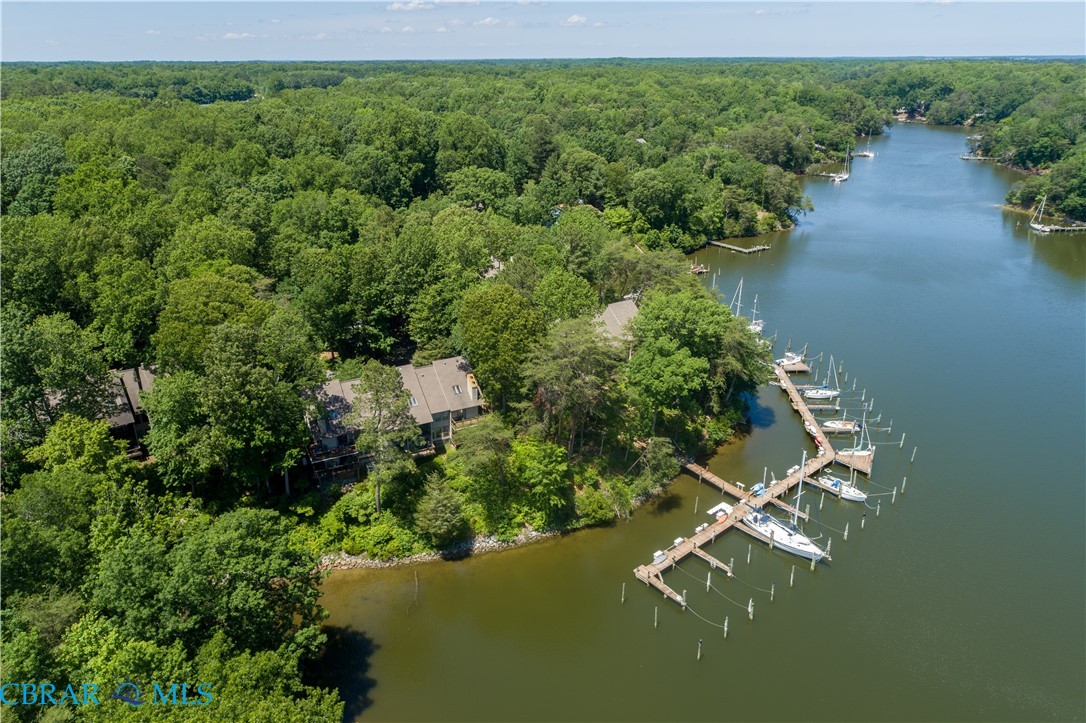 54 Villa Ridge Drive, Unit C Hartfield, VA 23071 - Photo 11 of 45 Drone / aerial view of a nearby body of water and a forest