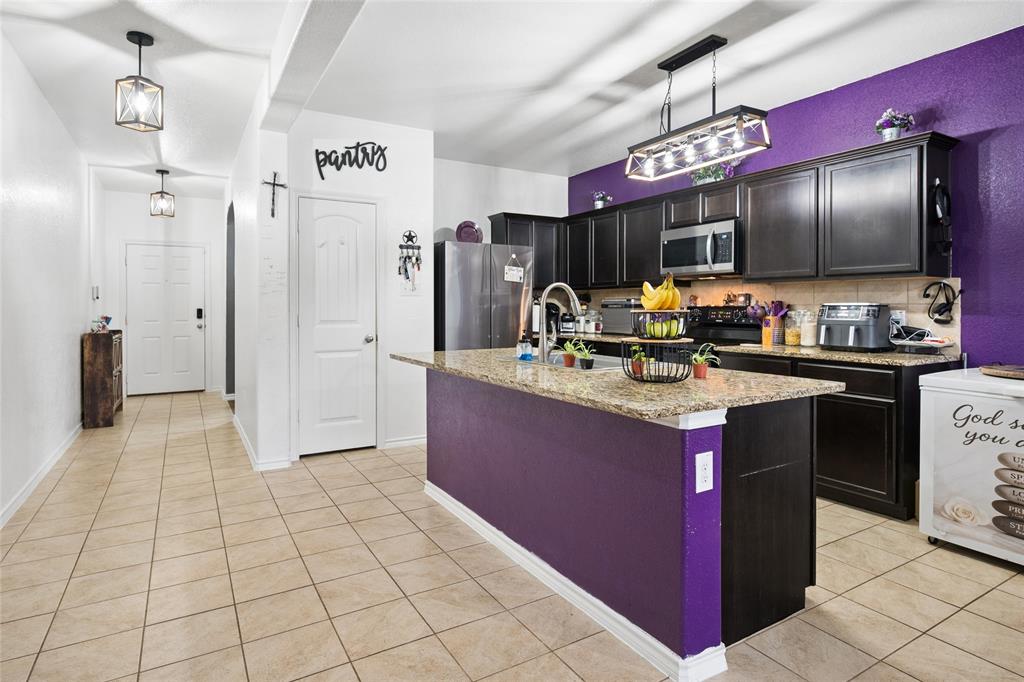 324 Fairgrounds Lane Ponder, TX 76259 - Photo 7 of 40 a kitchen with a sink refrigerator and a counter top space