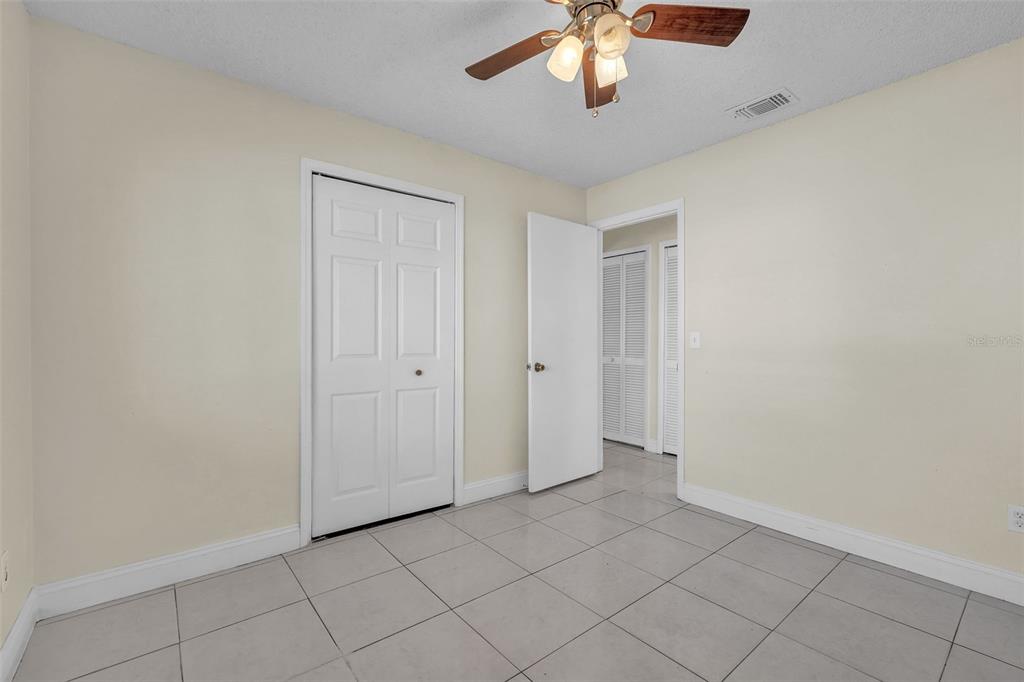 7724 Pengrove Pass Orlando, FL 32835 - Photo 17 of 24 an empty room with chandelier fan