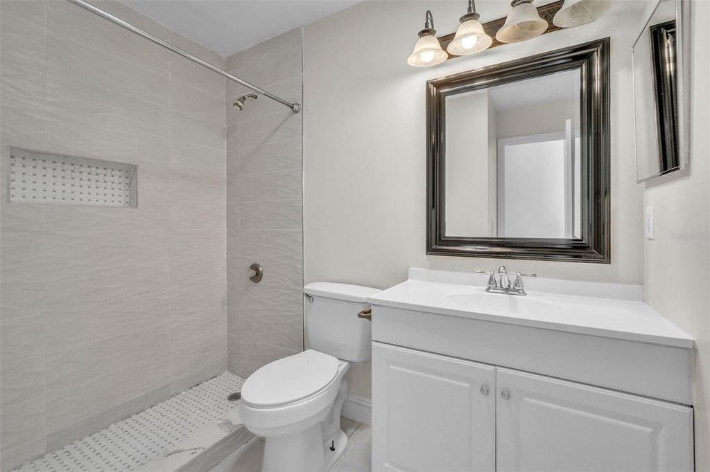 7724 Pengrove Pass Orlando, FL 32835 - Photo 18 of 24 a bathroom with a toilet sink and mirror