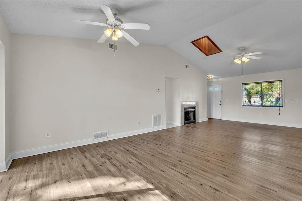 7724 Pengrove Pass Orlando, FL 32835 - Photo 8 of 24 wooden floor in an empty room with a window
