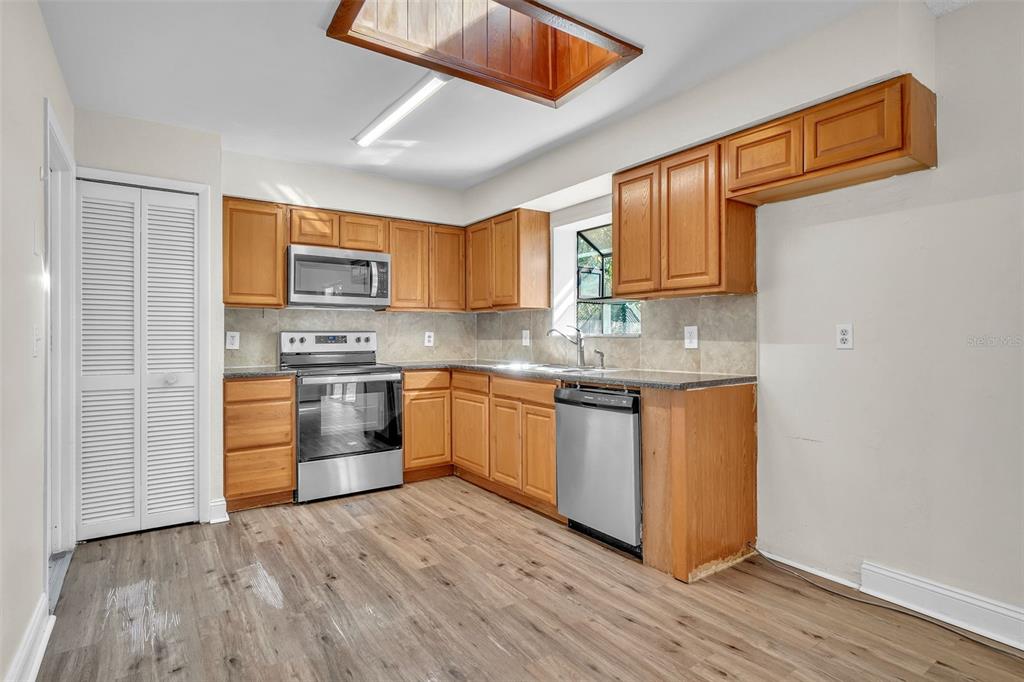 7724 Pengrove Pass Orlando, FL 32835 - Photo 10 of 24 a kitchen with stainless steel appliances granite countertop a stove a sink and a refrigerator