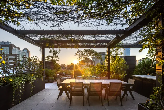 a view of a patio with table and chairs and potted plants