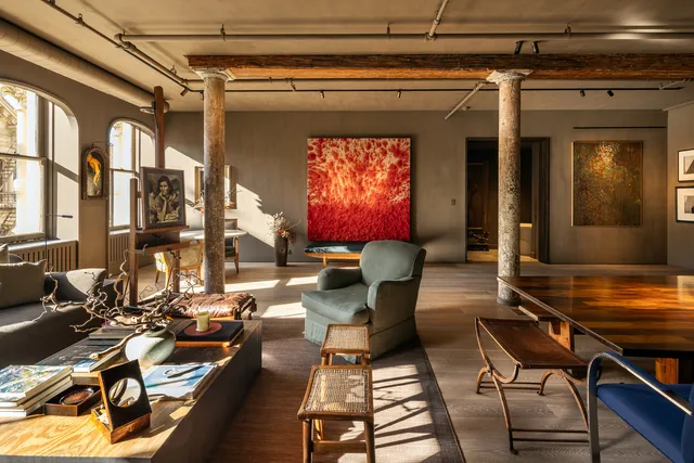 a living room with couches a dining table and chairs with wooden floor