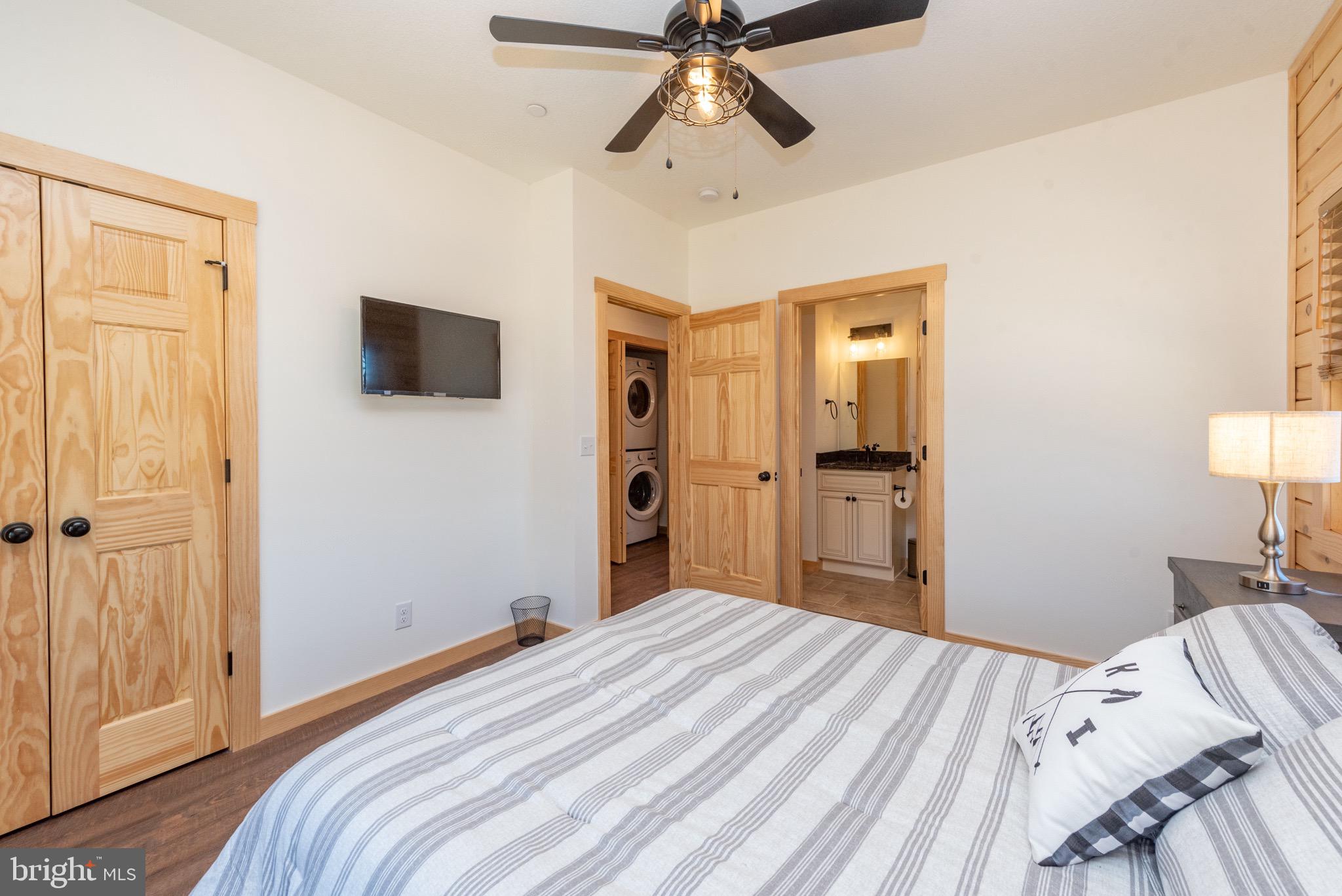 828 North Camp Road McHenry, MD 21541 - Photo 18 of 59 a bedroom with a bed and a flat screen tv