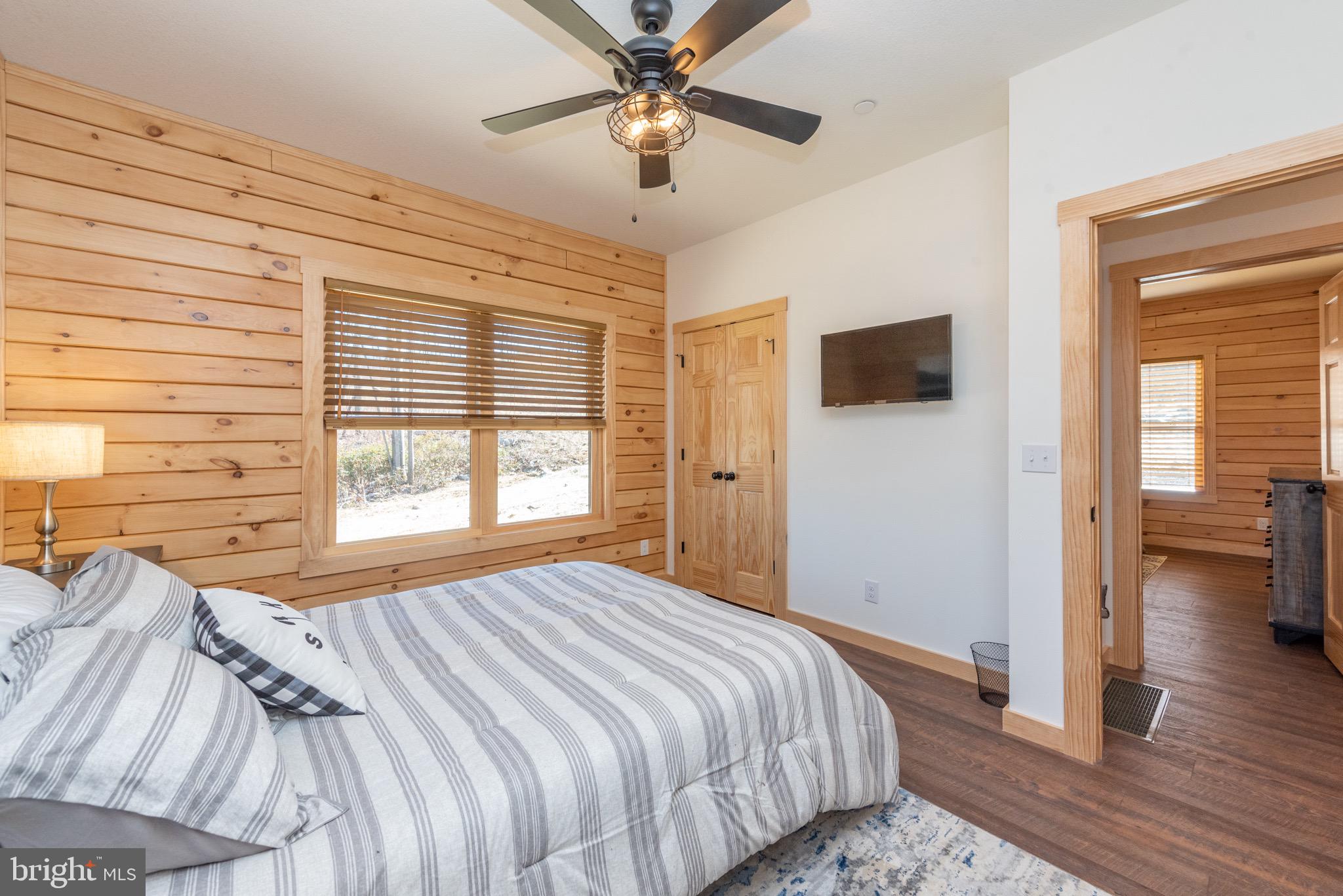 828 North Camp Road McHenry, MD 21541 - Photo 20 of 59 a bedroom with a bed and a chandelier