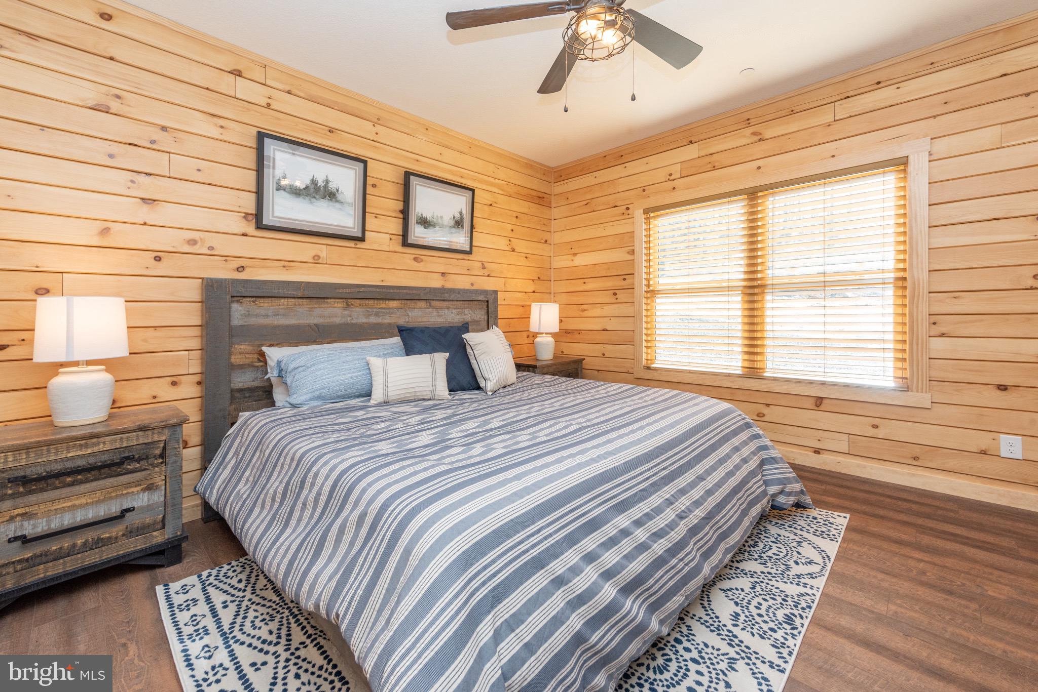 828 North Camp Road McHenry, MD 21541 - Photo 24 of 59 a bedroom with a bed and wooden floor