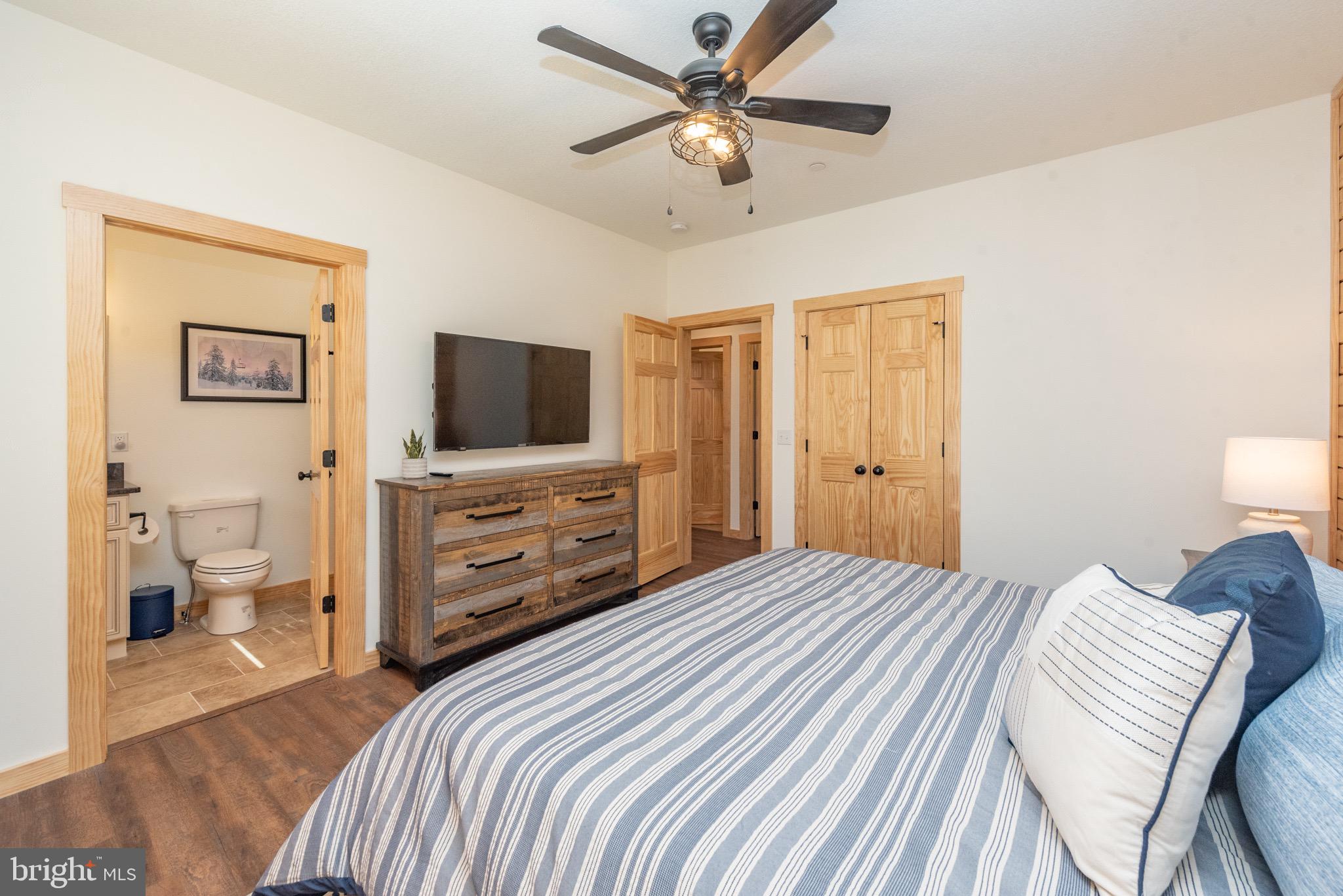 828 North Camp Road McHenry, MD 21541 - Photo 26 of 59 a bedroom with a bed and a flat screen tv