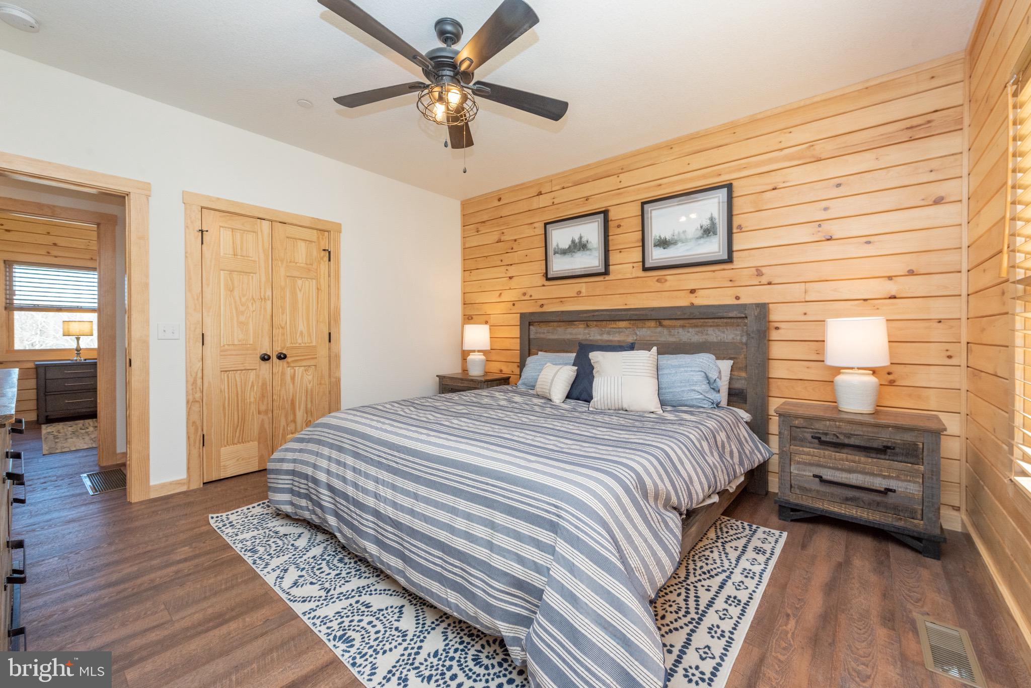 828 North Camp Road McHenry, MD 21541 - Photo 27 of 59 a bedroom with a large bed and a chandelier