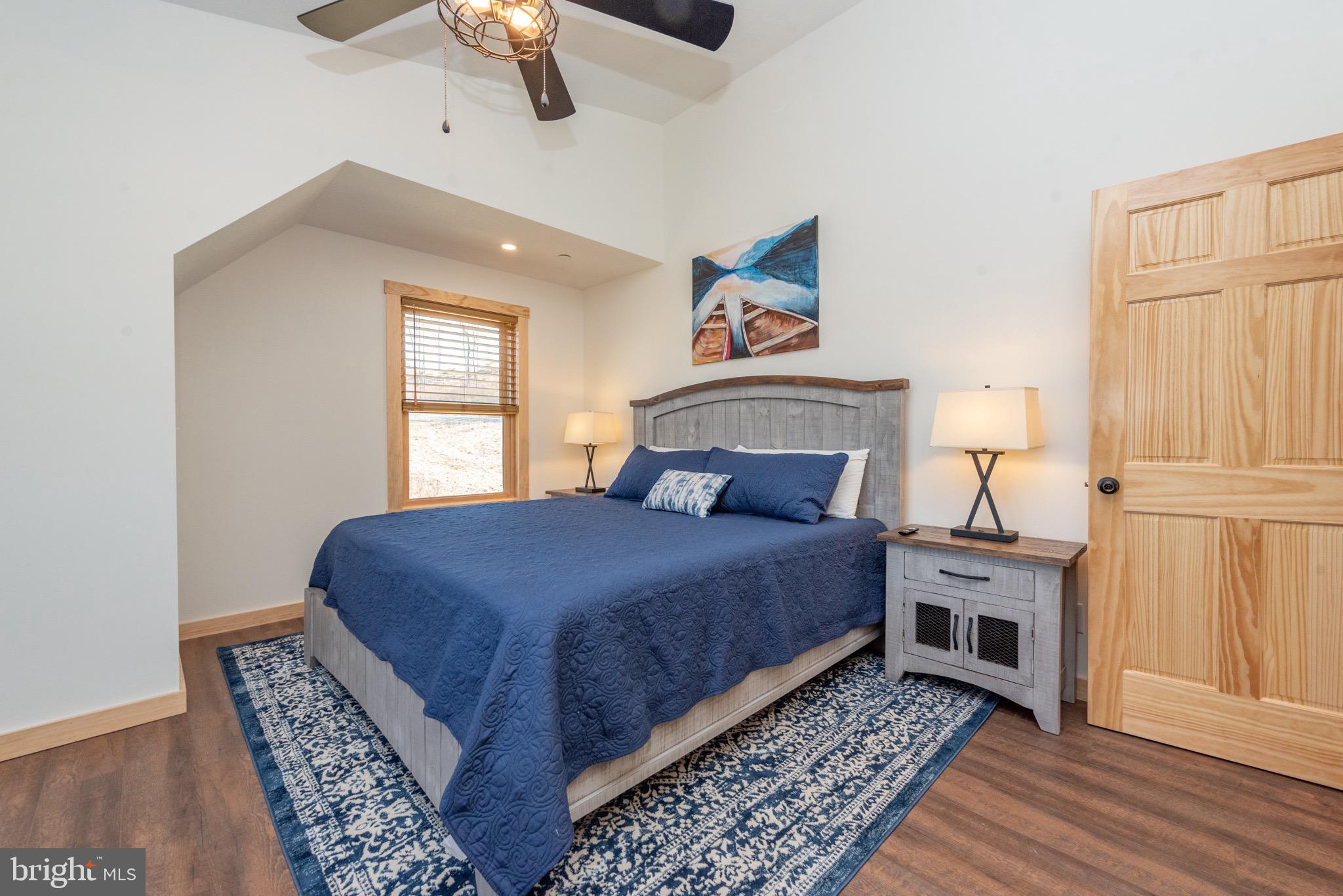 828 North Camp Road McHenry, MD 21541 - Photo 28 of 59 a bedroom with a bed rug and wooden floor