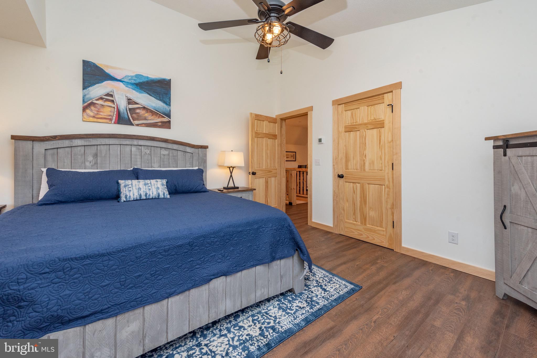 828 North Camp Road McHenry, MD 21541 - Photo 31 of 59 a bedroom with a bed and a chandelier