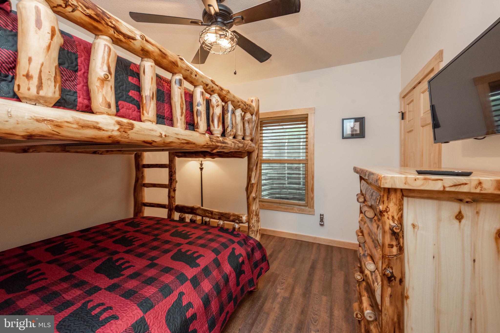 828 North Camp Road McHenry, MD 21541 - Photo 45 of 59 a bedroom with a bed and a chandelier