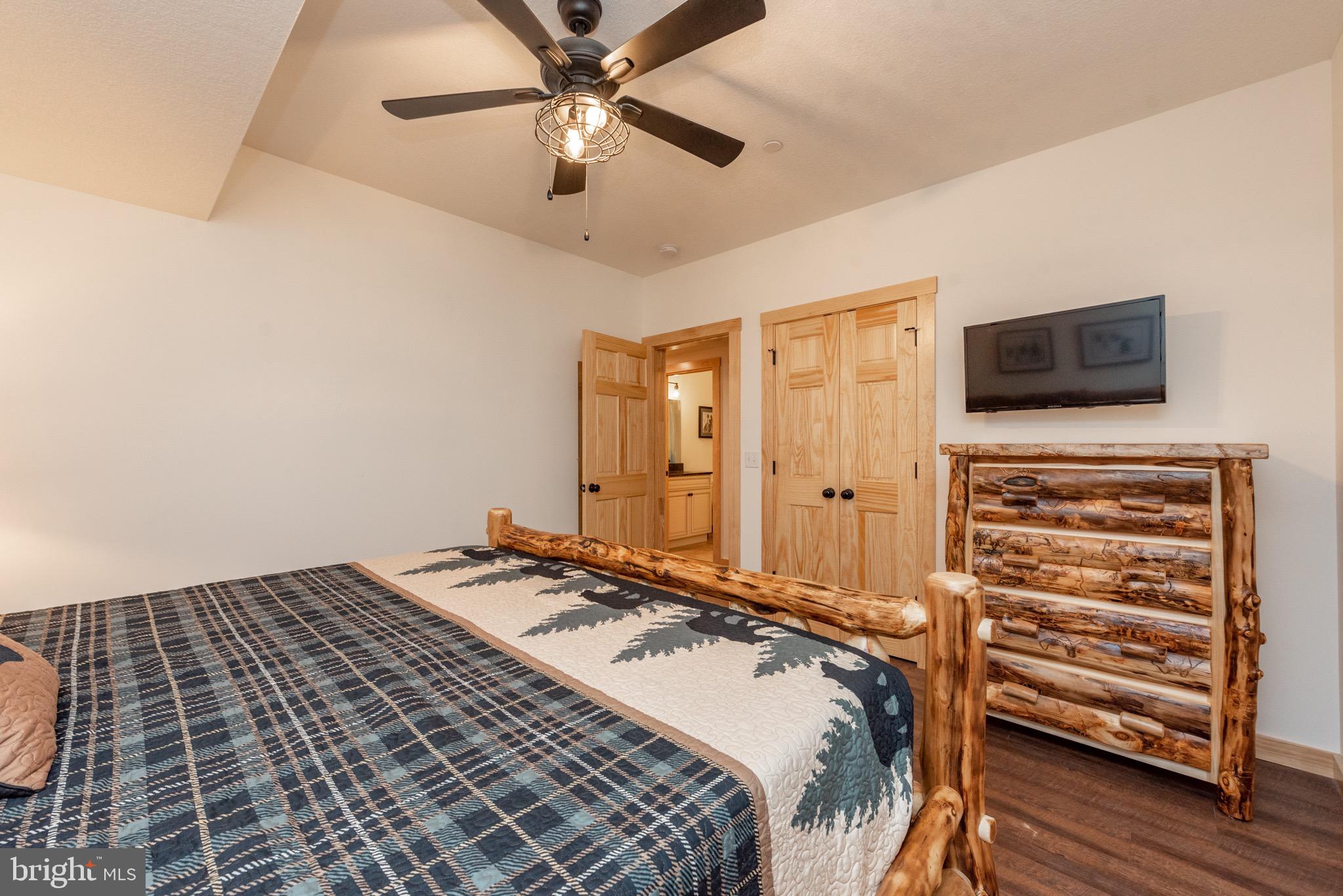 828 North Camp Road McHenry, MD 21541 - Photo 49 of 59 a bedroom with a bed and a flat tv screen