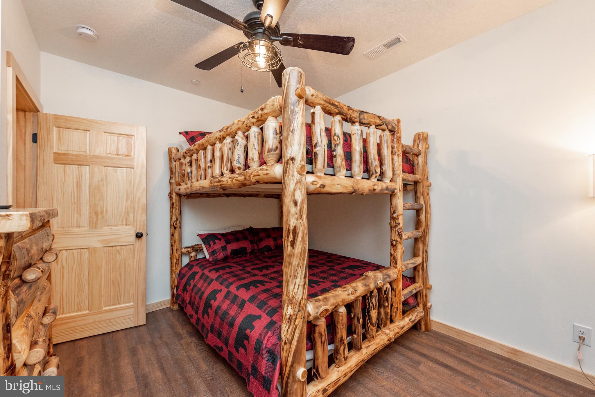 828 North Camp Road McHenry, MD 21541 - Photo 50 of 59 a bed sitting in a bedroom next to a window