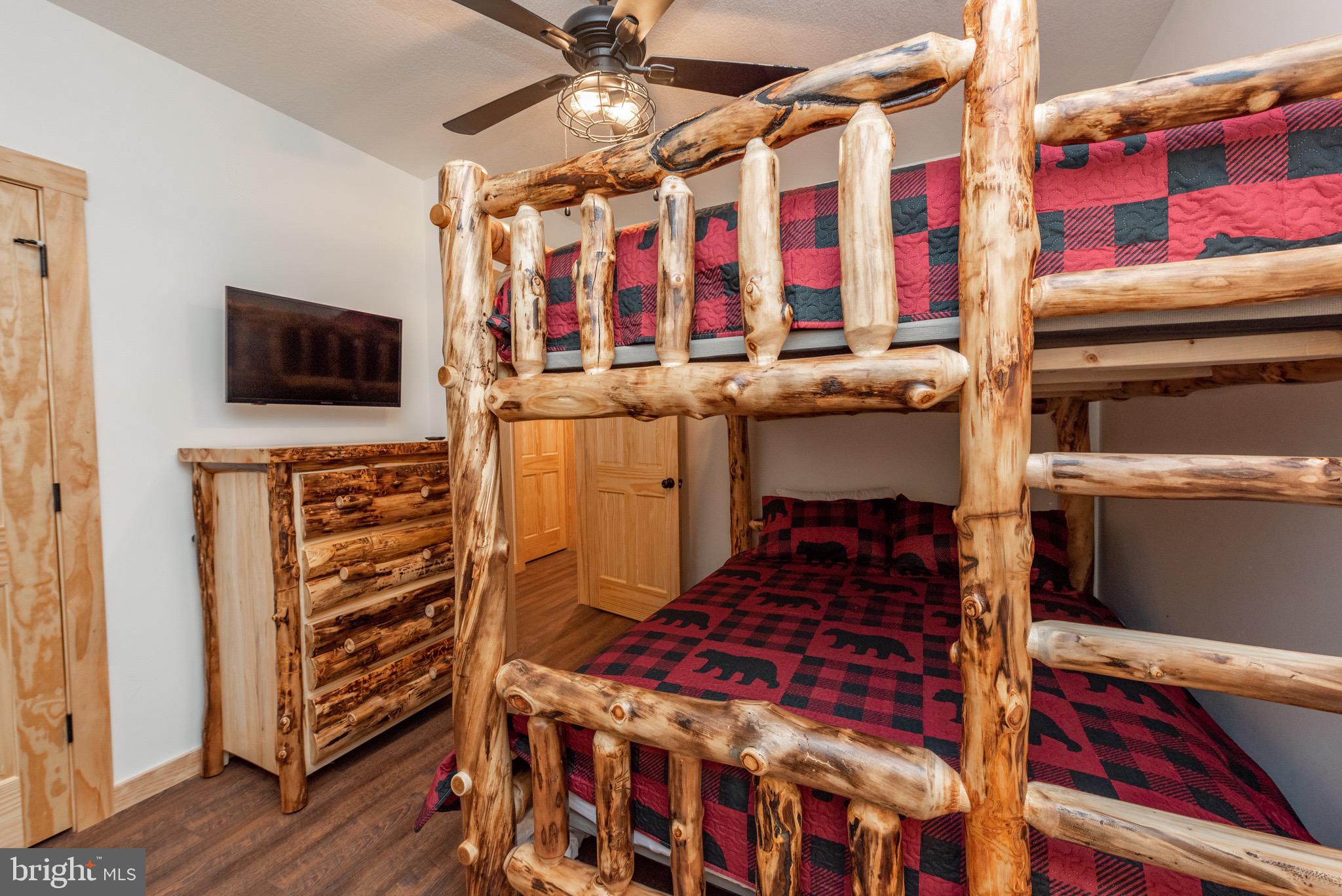 828 North Camp Road McHenry, MD 21541 - Photo 51 of 59 a bedroom with a bed and a flat tv screen