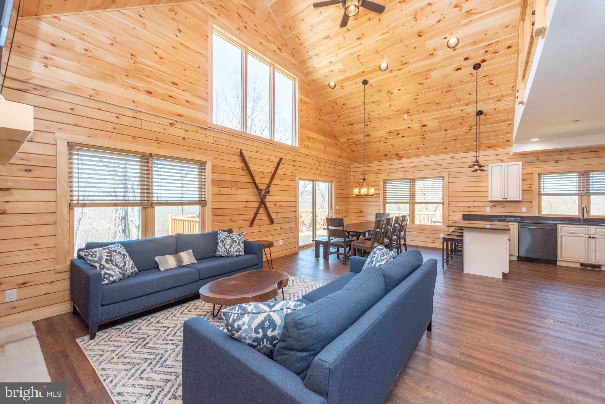 828 North Camp Road McHenry, MD 21541 - Photo 6 of 59 a living room with furniture wooden floor and kitchen view