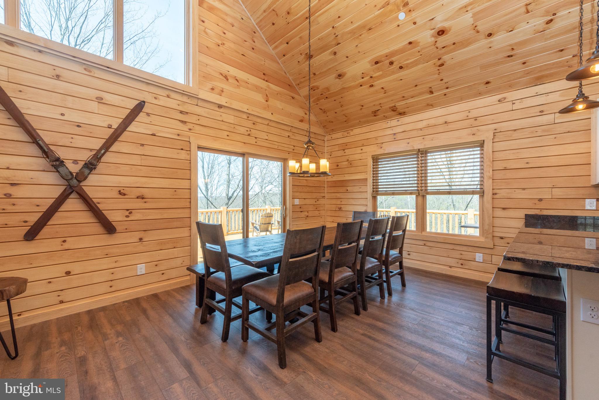 828 North Camp Road McHenry, MD 21541 - Photo 10 of 59 a view of a dining room with furniture and wooden floor