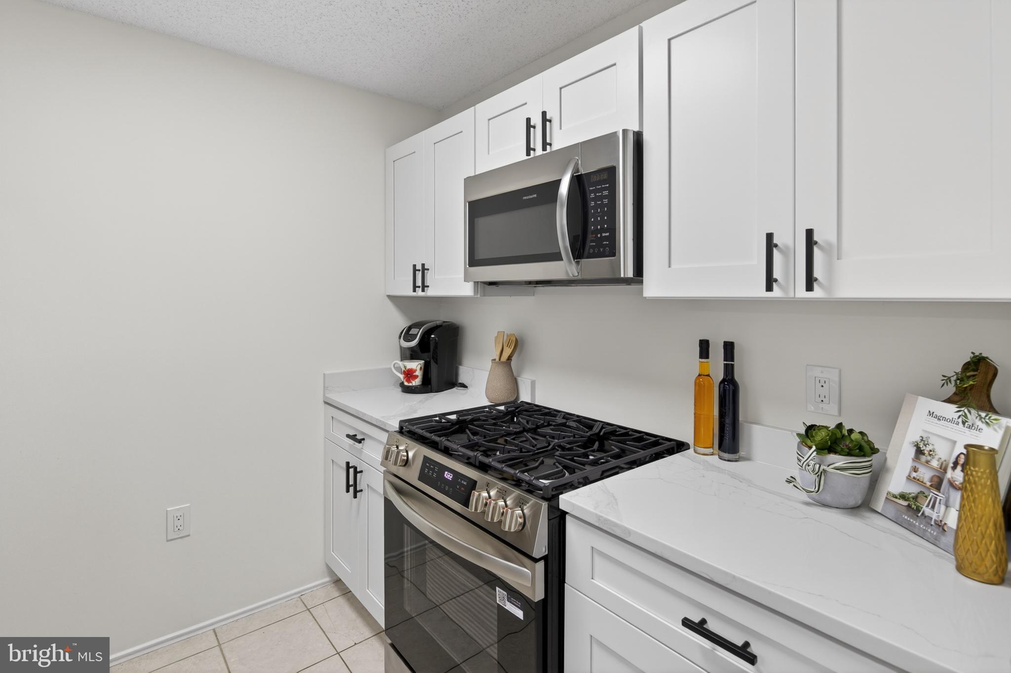 21009 Timber Ridge Terrace, Unit 203 Ashburn, VA 20147 - Photo 36 of 38 Modern kitchen with sleek finishes.