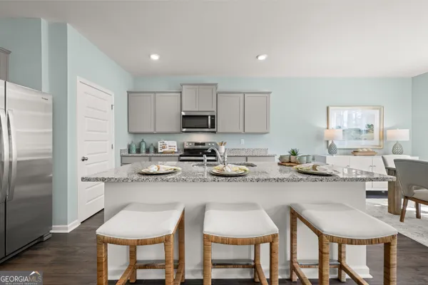 a kitchen with granite countertop a stove sink and cabinets
