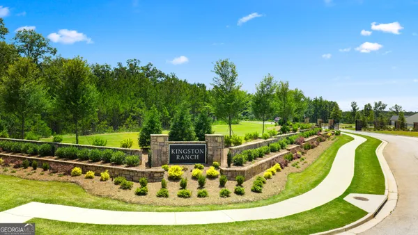 a view of a swimming pool with a fountain and a yard