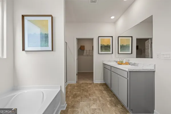 a living room with furniture kitchen view and a wooden floor