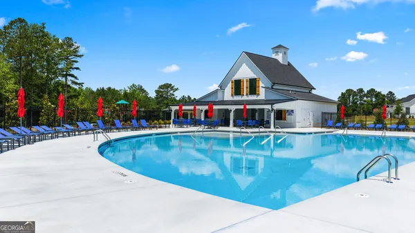 a view of water fountain in front of retail shop