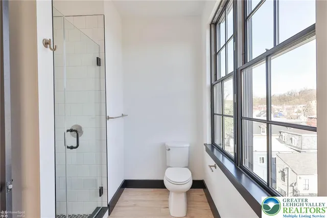 a bathroom with a toilet and a shower