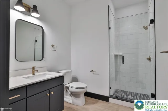 a bathroom with a toilet sink and shower