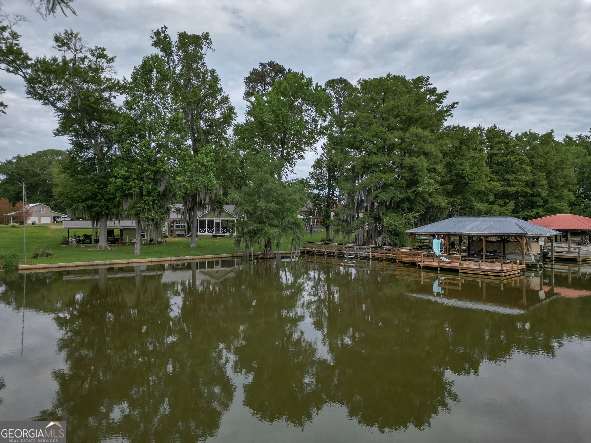 a view of a lake with a house in the background