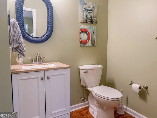 a bathroom with a toilet a sink and a mirror