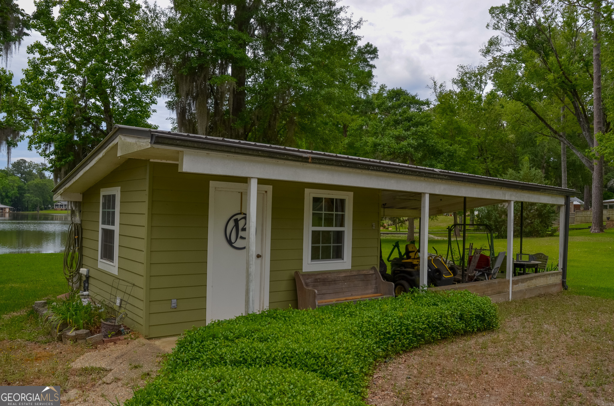 110 Tom Holman Road Cobb, GA 31735 - Photo 16 of 18 a front view of a house with garden