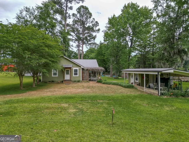 a front view of house with yard and green space