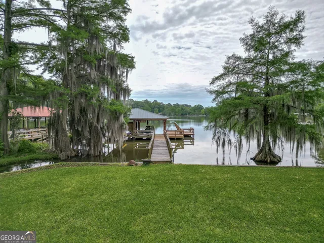 a swimming pool with outdoor seating and garden